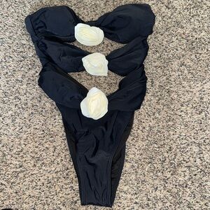 Black one piece swimsuit with white roses.